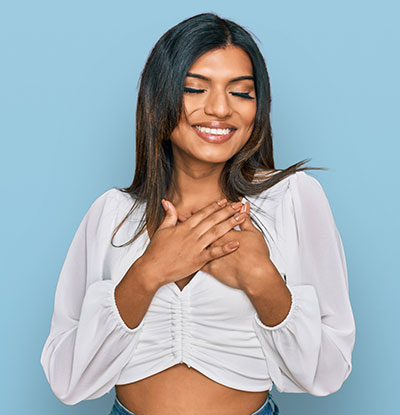 Facial feminisation surgery transgender model, happy with eyes closed Facial feminisation surgery transgender model, happy with eyes closed